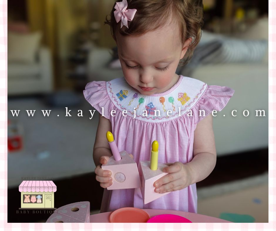 Celebrate in Style with the Petit Bebe Pink Gingham Smocked Birthday Bishop Dress